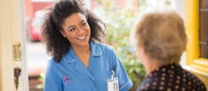 Senior adult care worker smiling while working with the elderly