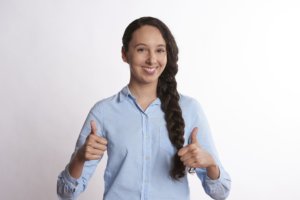 Thumbs up woman with tidy braided hair